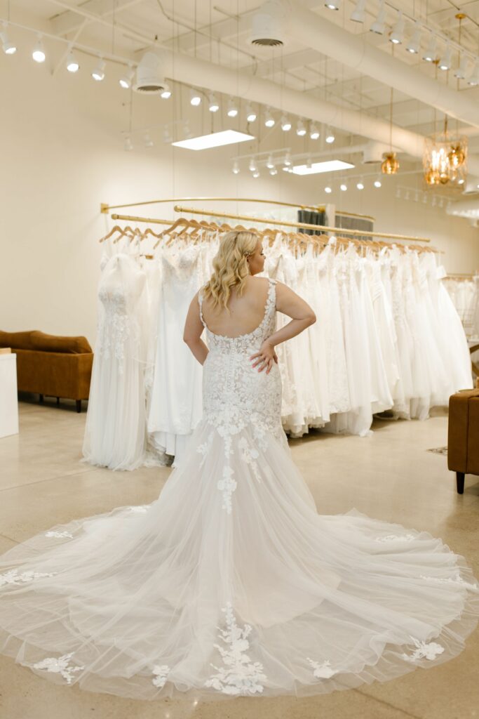 woman showing the train of her ivory lace wedding dress