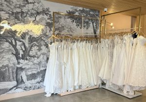 Interior of Ivoryology Denver boutique with curated racks of off-the-rack wedding dresses