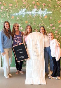 Bride celebrating finding her wedding dress with family at Ivoryology Tacoma bridal boutique