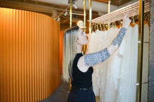 Bride shopping for wedding dresses in Denver at Ivoryology with stylist assistance