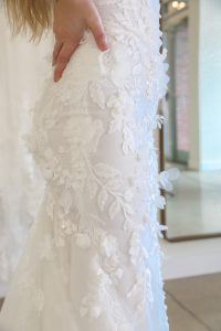 close-up of intricate floral lace on an affordable off-the-rack wedding dress available at Ivoryology in Memphis.
